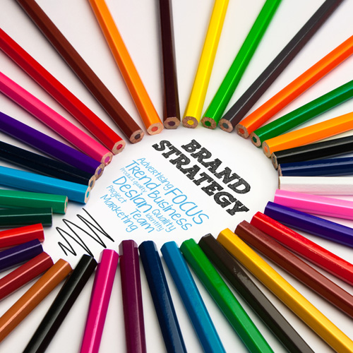 Colored pencils making a lightbulb shape with the text, "Brand Strategy"