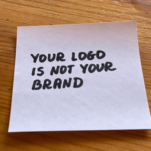 Sticky note with the text, "Your Logo is Not Your Brand"